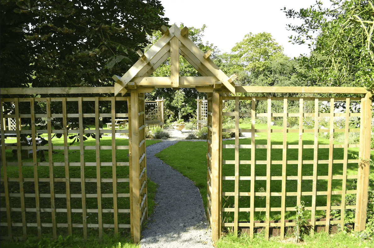 Timber trellis screen fencing providing privacy and style in a garden.