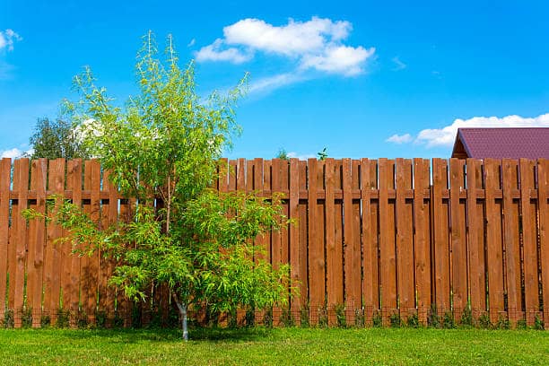 Wooden fence surrounding a country house with a selective focus effect.